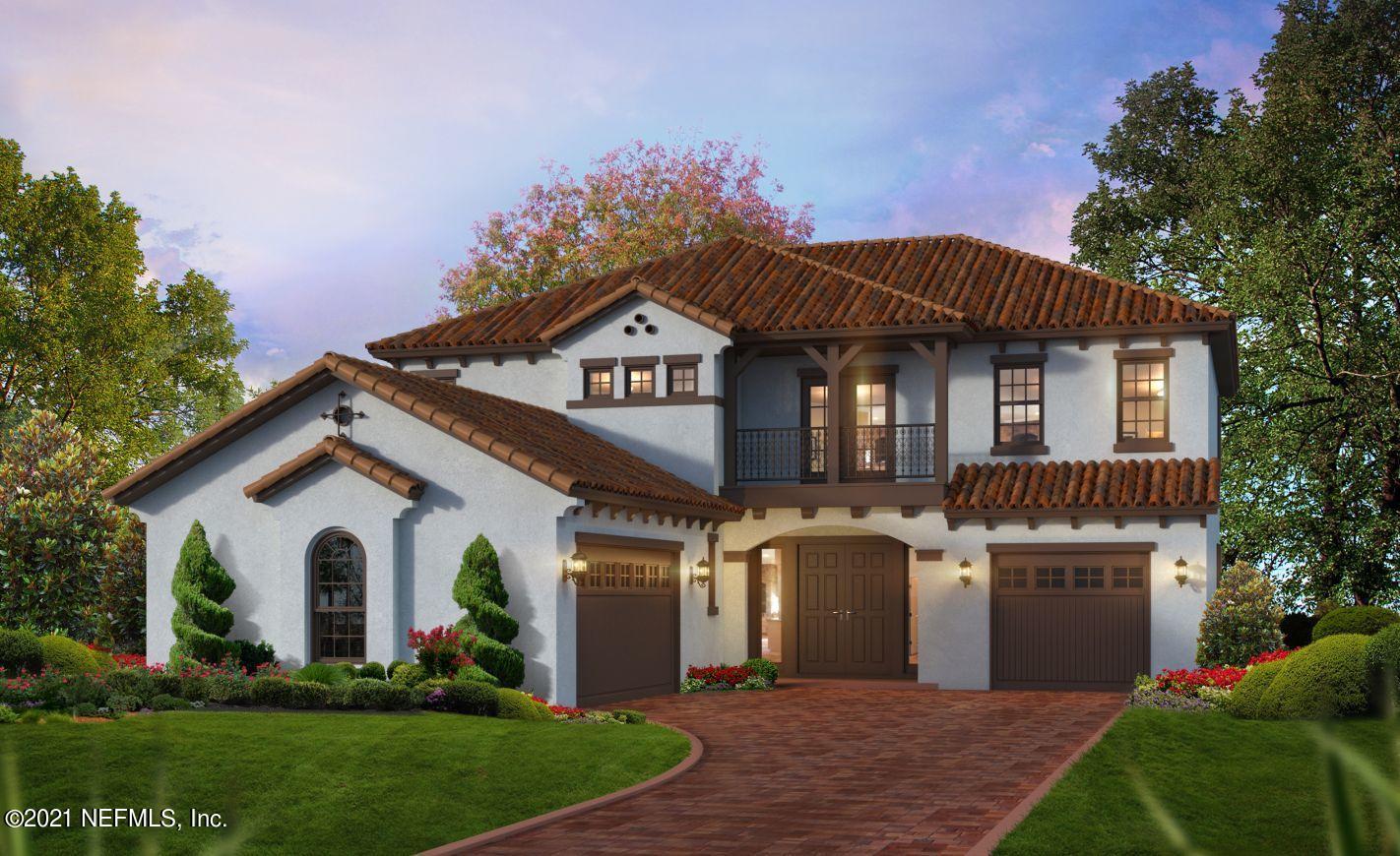 a front view of a house with a garden and plants