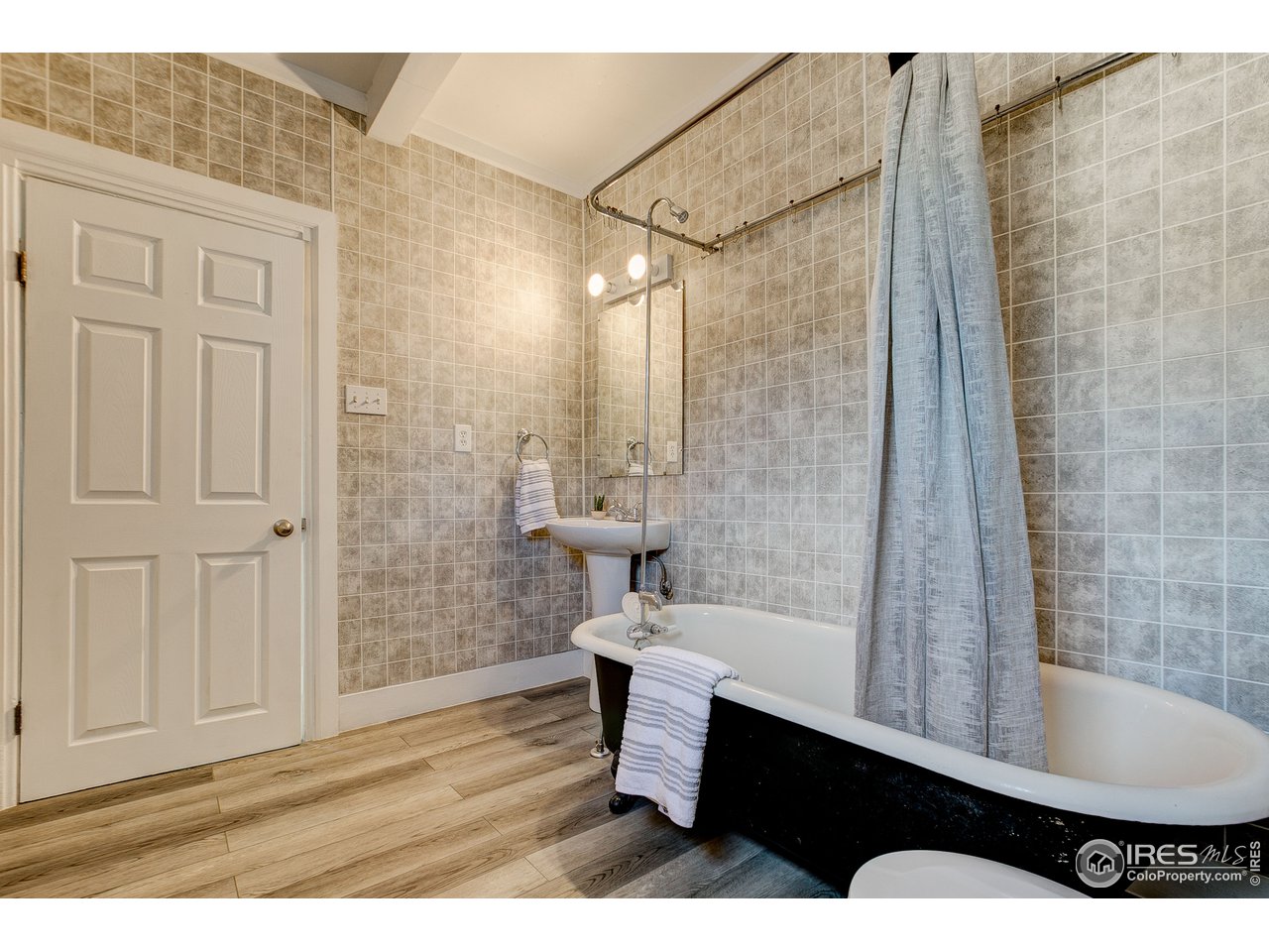 26 Main Street Windsor, CO 80550 - Photo 15 of 22 a bathroom with a sink a toilet and shower