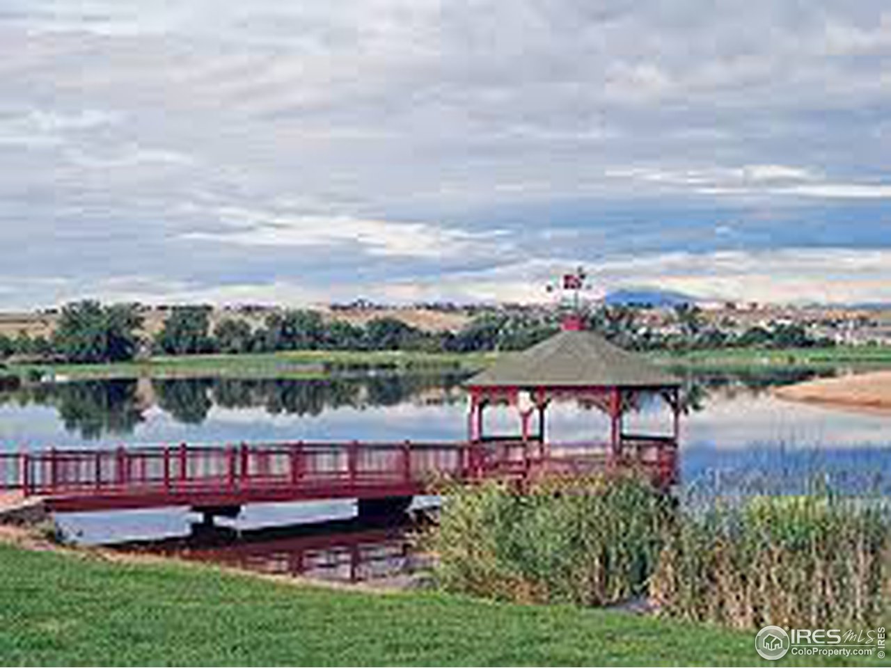 26 Main Street Windsor, CO 80550 - Photo 21 of 22 a view of a lake with a table and chairs
