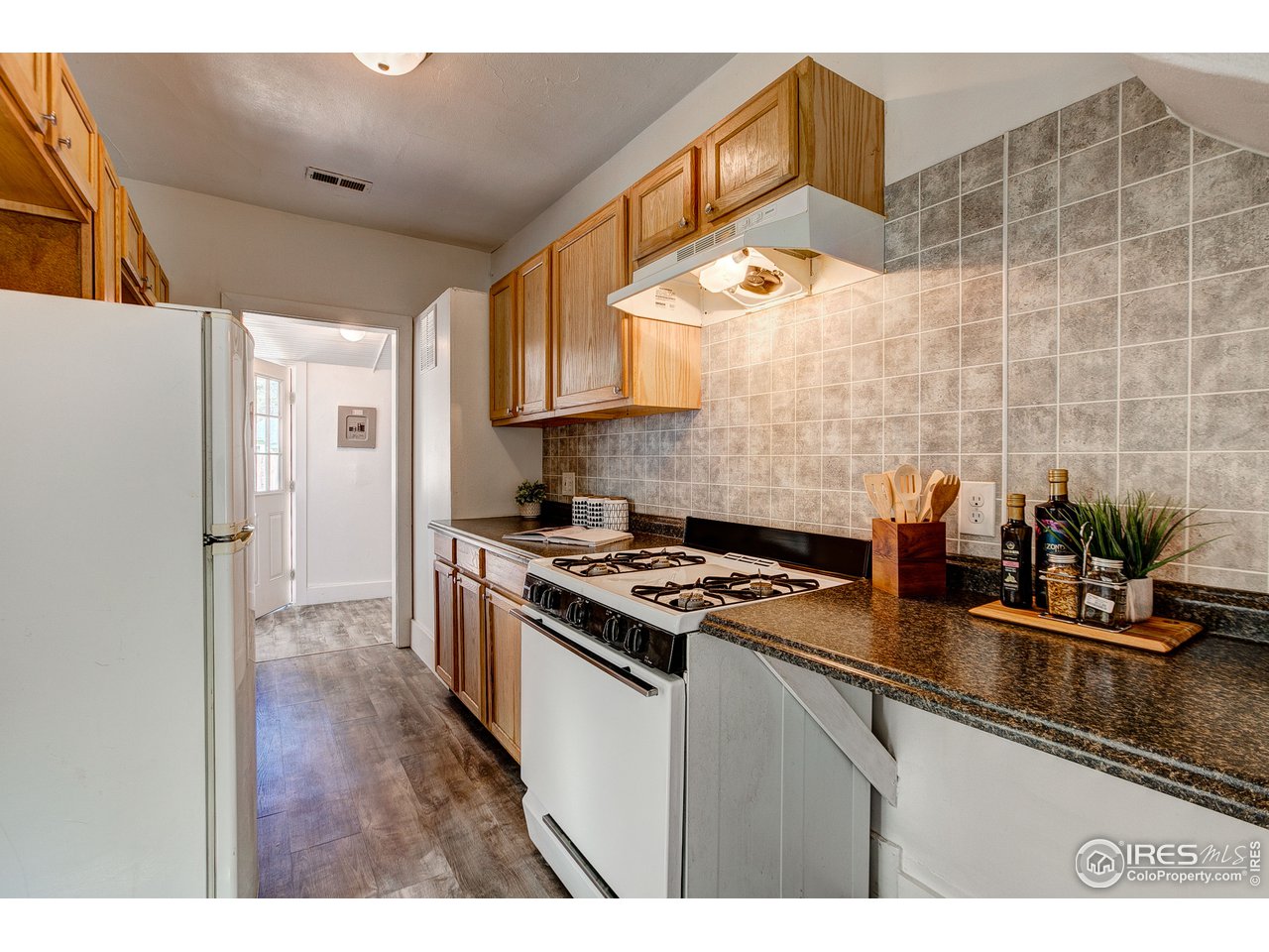 26 Main Street Windsor, CO 80550 - Photo 7 of 22 a kitchen with stainless steel appliances granite countertop a sink stove and cabinets