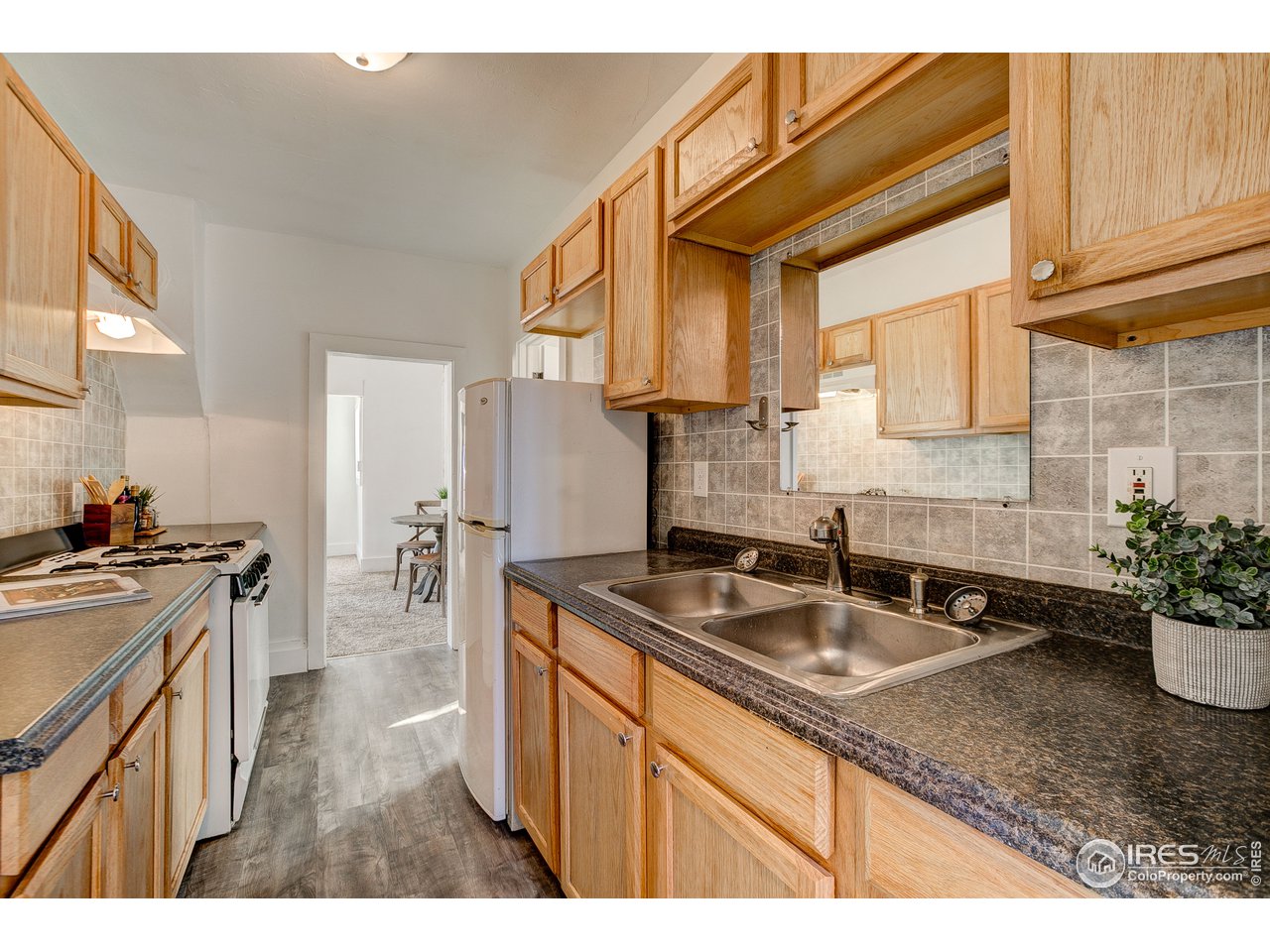26 Main Street Windsor, CO 80550 - Photo 8 of 22 a kitchen with stainless steel appliances granite countertop a sink stove and cabinets