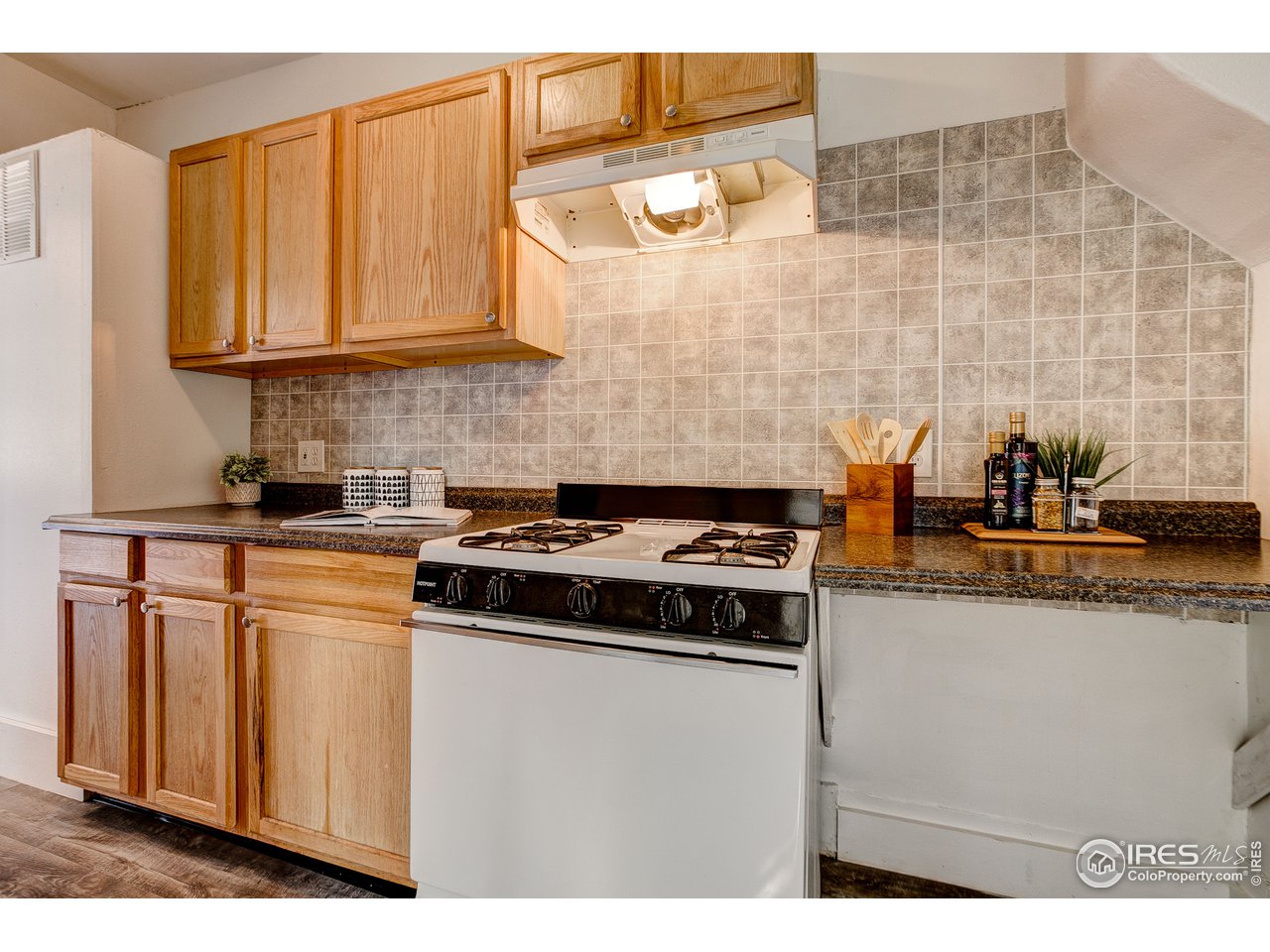 26 Main Street Windsor, CO 80550 - Photo 9 of 22 a kitchen with stainless steel appliances granite countertop a stove a sink and a microwave