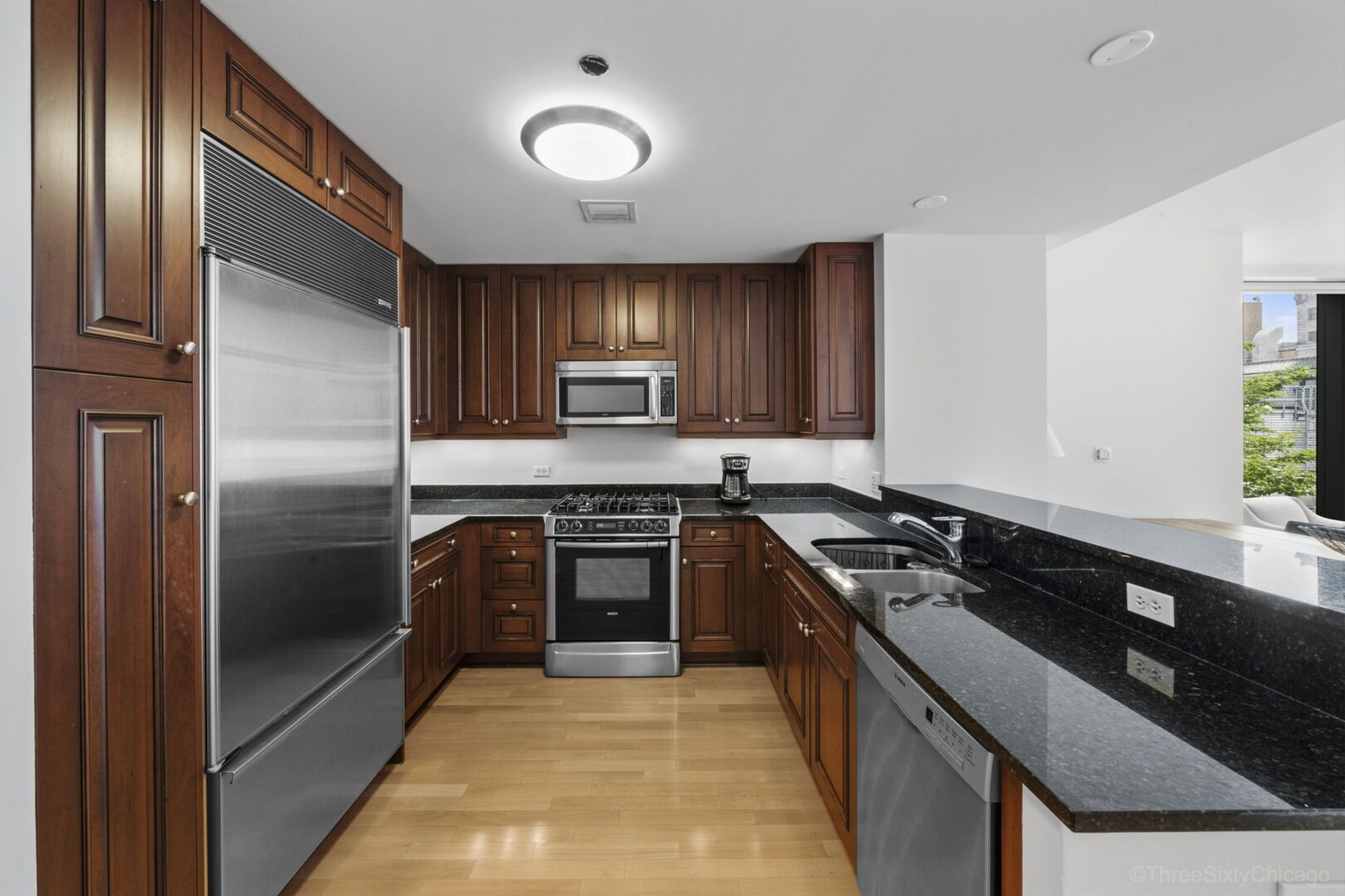 60 East Monroe Street, Unit 1604 Chicago, IL 60603 - Photo 12 of 34 a kitchen with a refrigerator sink and stove