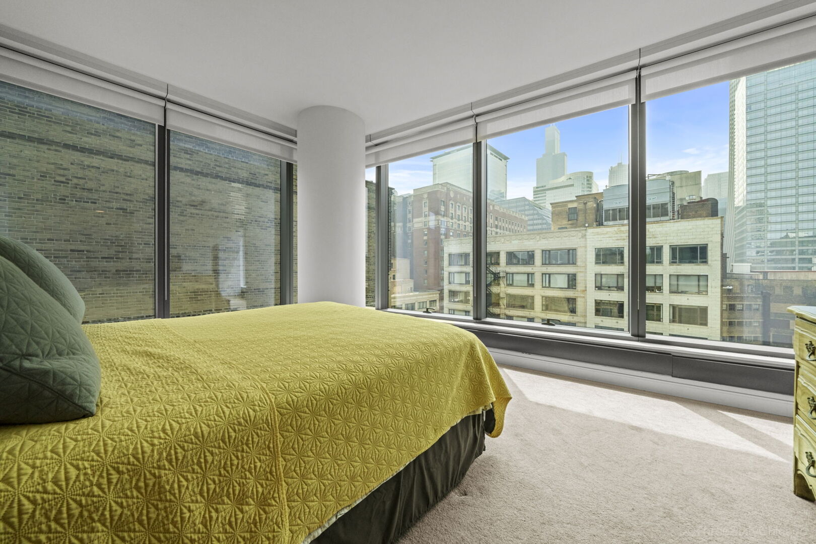 60 East Monroe Street, Unit 1604 Chicago, IL 60603 - Photo 17 of 34 a bed sitting in a bedroom next to a window