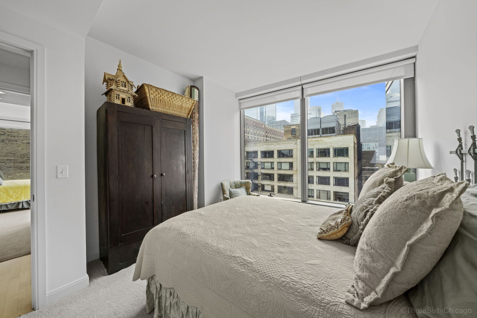 60 East Monroe Street, Unit 1604 Chicago, IL 60603 - Photo 21 of 34 a bedroom with a bed and a large window