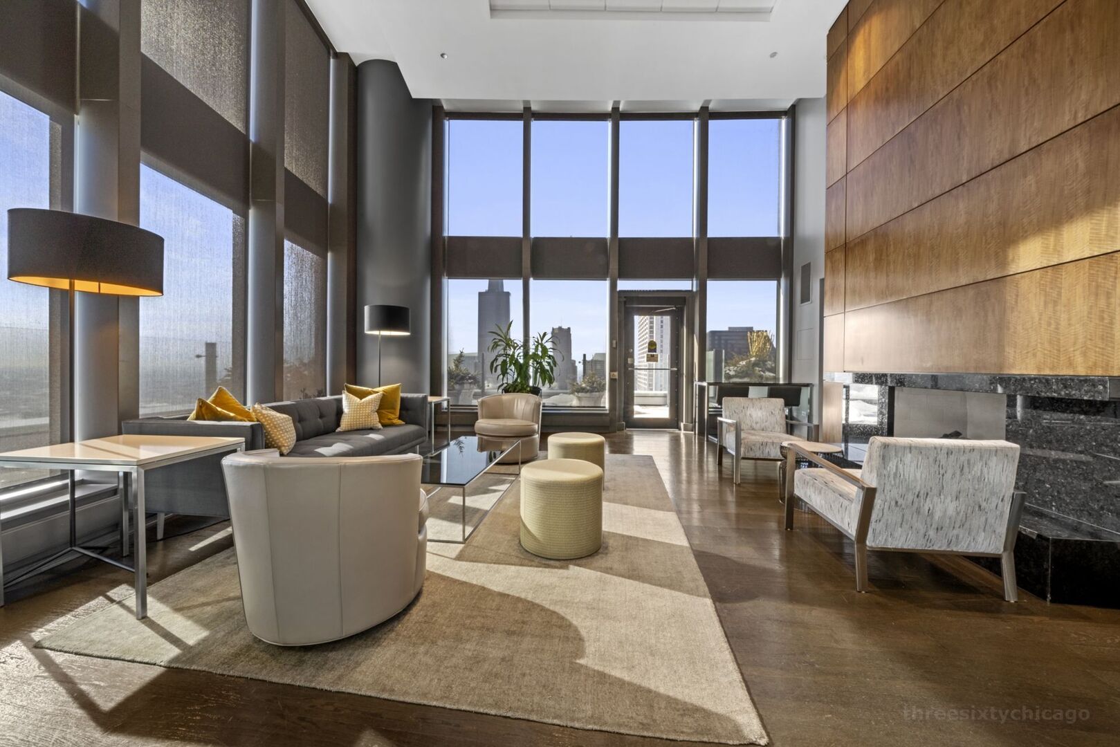 60 East Monroe Street, Unit 1604 Chicago, IL 60603 - Photo 28 of 34 a living room with couches a coffee table and a large window with garden view