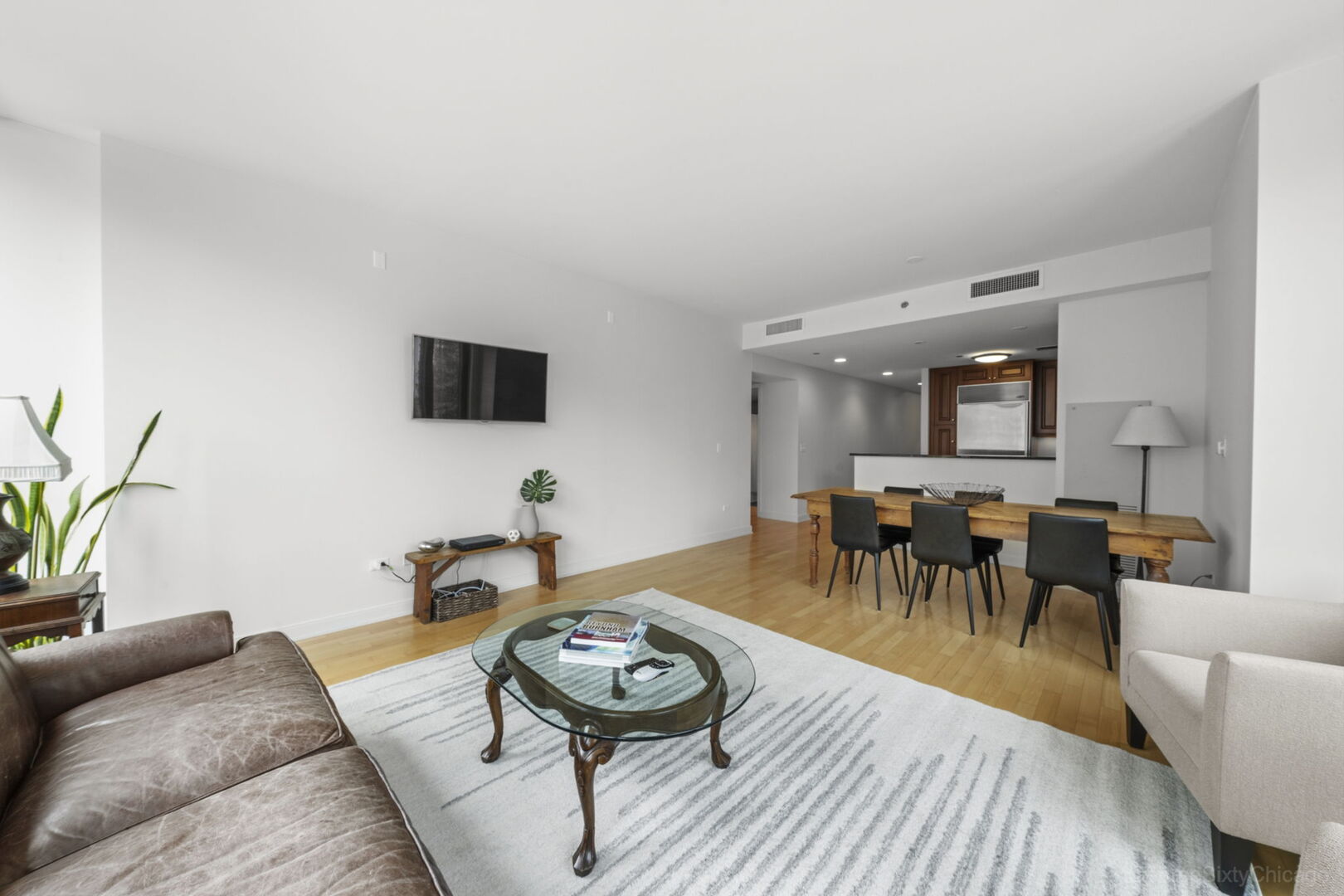 60 East Monroe Street, Unit 1604 Chicago, IL 60603 - Photo 5 of 34 a living room with furniture and a wooden floor