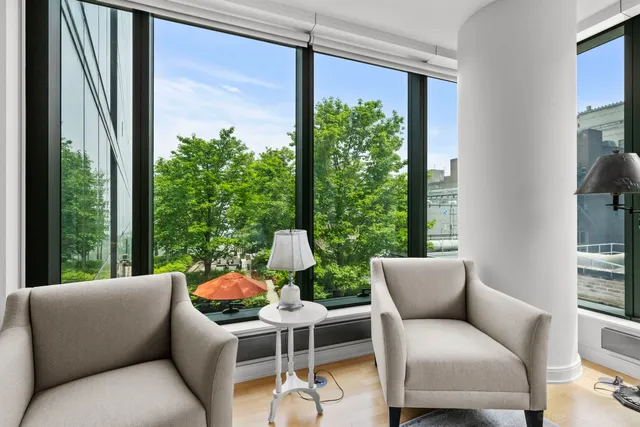 a balcony with furniture and a potted plant