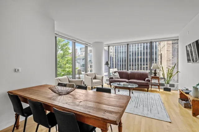 a view of living room filled with furniture and wooden floor