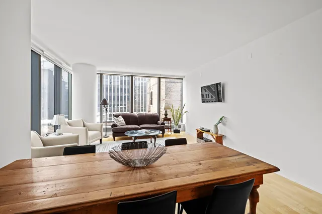 a dinning room with kitchen island a table and chairs in it