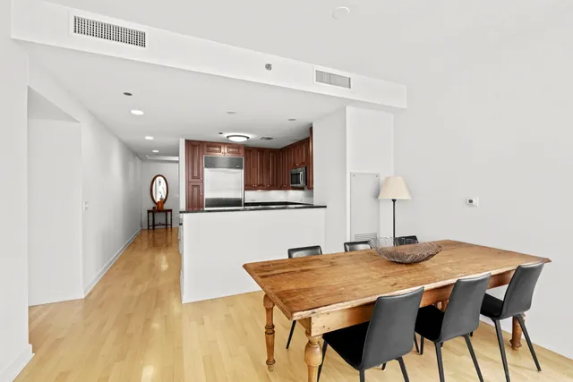 a kitchen with stainless steel appliances granite countertop a sink a stove and a refrigerator