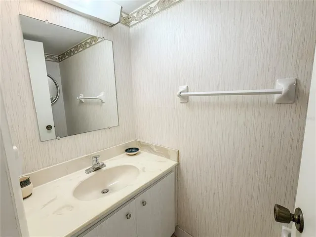 a bathroom with a sink and mirror