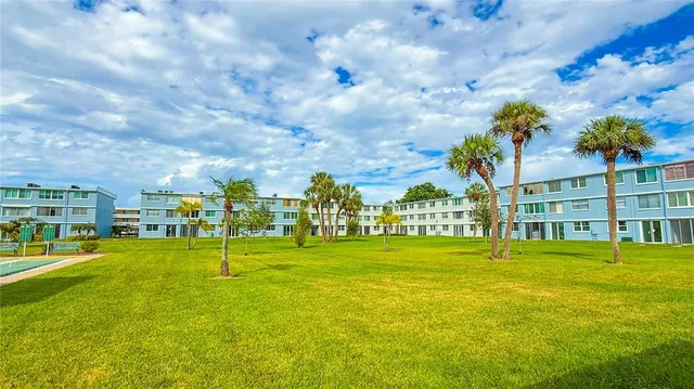 a view of a swimming pool with a garden and trees