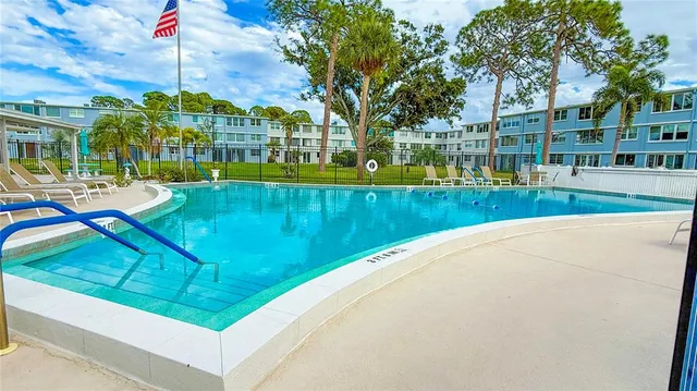 a swimming pool with outdoor seating and yard