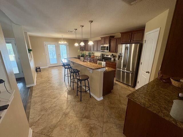 3012 Crown Creek Circle Crestview, FL 32539 - Photo 9 of 22 a kitchen with stainless steel appliances granite countertop a sink stove and refrigerator