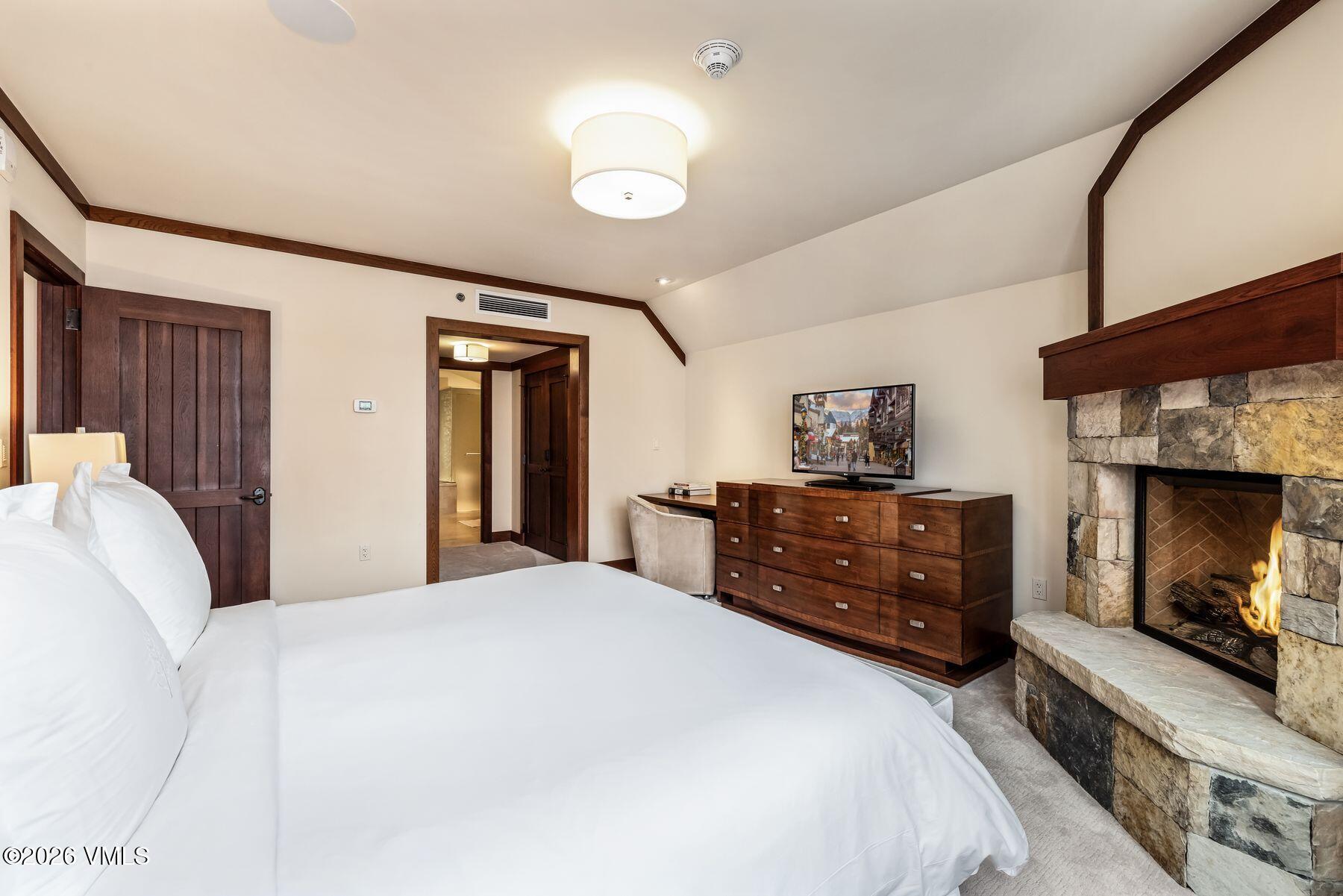 1 Vail Road, Unit 9204 Vail, CO 81657 - Photo 15 of 27 a bedroom with a bed and a fireplace