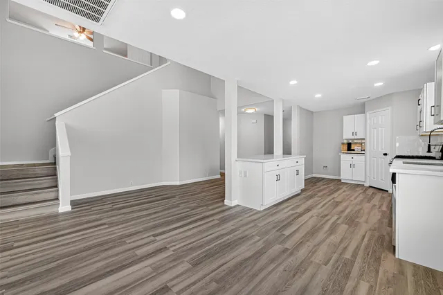 a view of kitchen with wooden floor and electronic appliances