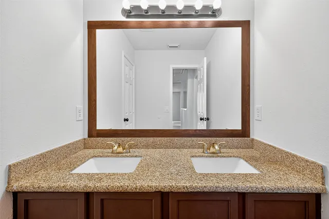 a bathroom with sink and granite