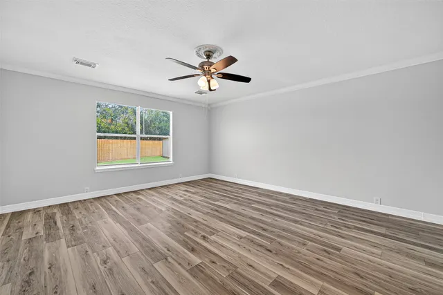 wooden floor in an empty room with a window