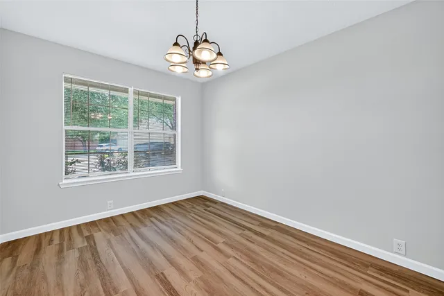 a view of wooden floor and windows in a room
