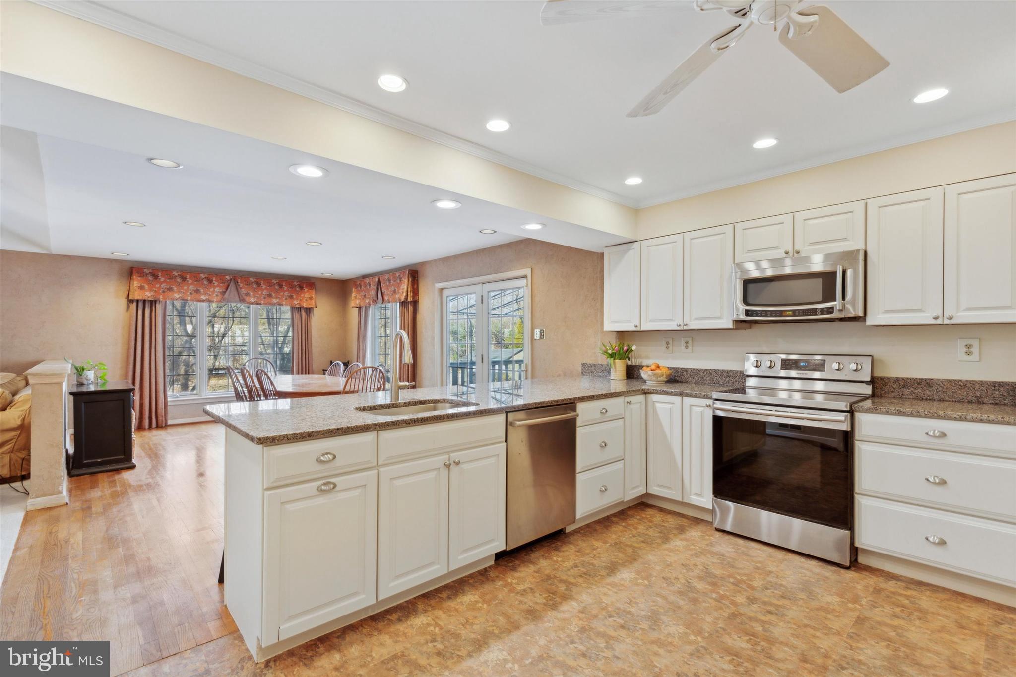 629 Colonel Dewees Road Wayne, PA 19087 - Photo 9 of 34 a kitchen with stainless steel appliances granite countertop a sink and cabinets
