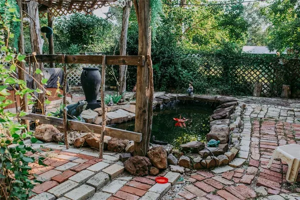 a view of a street with plants and a fountain