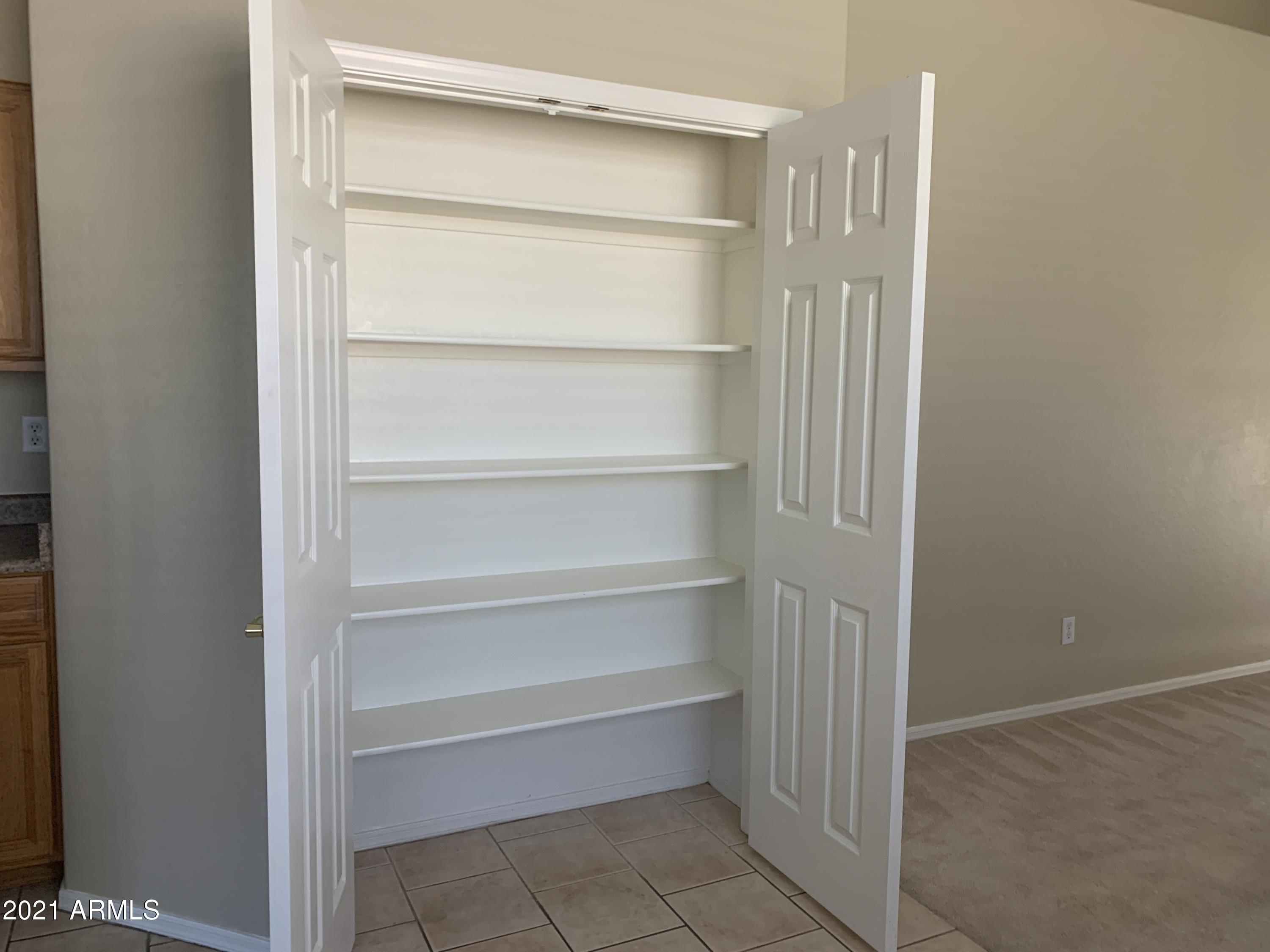 10460 South 182nd Drive Goodyear, AZ 85338 - Photo 21 of 33 a view of an empty walk in closet
