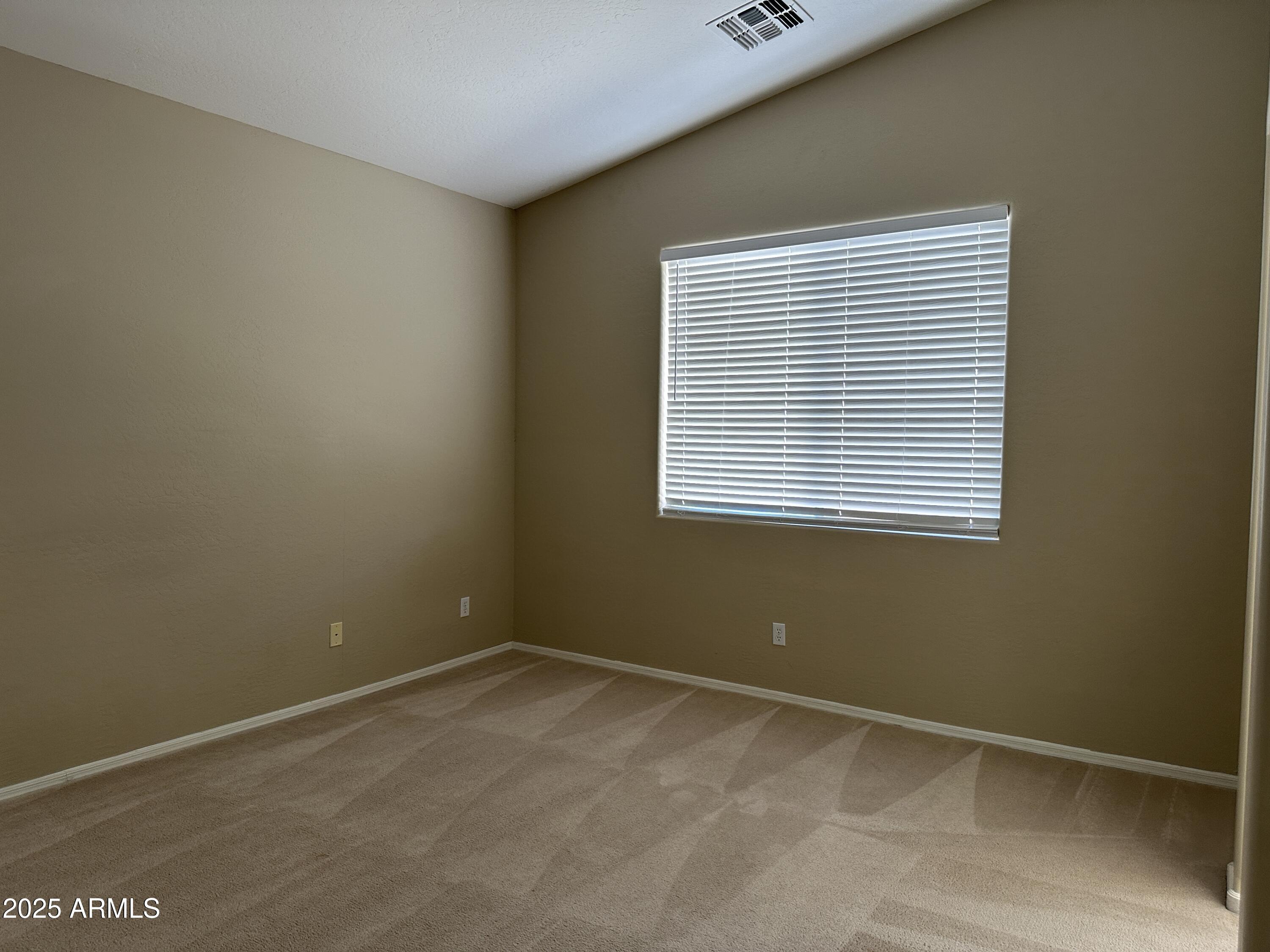 10460 South 182nd Drive Goodyear, AZ 85338 - Photo 8 of 33 a view of an empty room with a window
