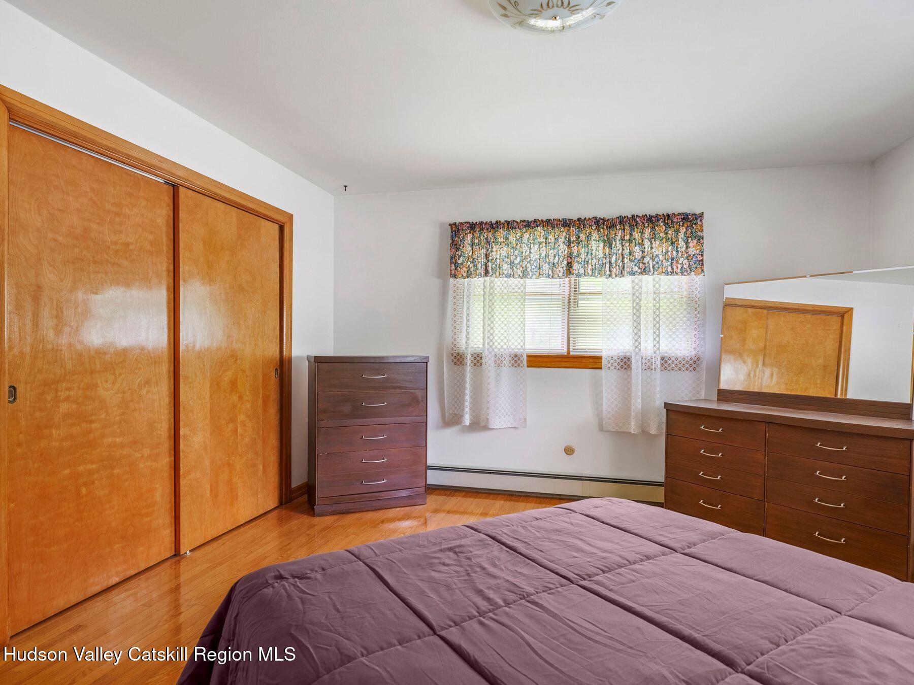 104 New Paltz Road Highland, NY 12528 - Photo 17 of 43 a bedroom with a bed and a dresser