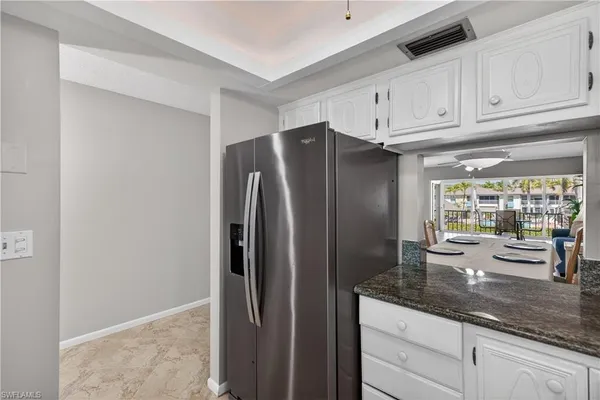 a kitchen with stainless steel appliances granite countertop a refrigerator and a sink