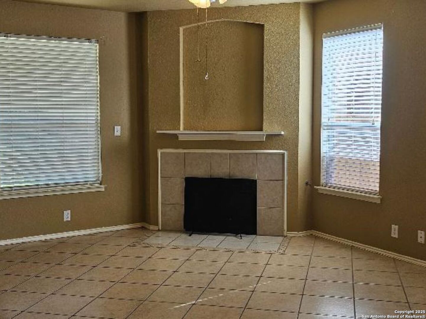 9019 Burnt Peak Helotes, TX 78023 - Photo 4 of 11 a view of a livingroom with a fireplace and window