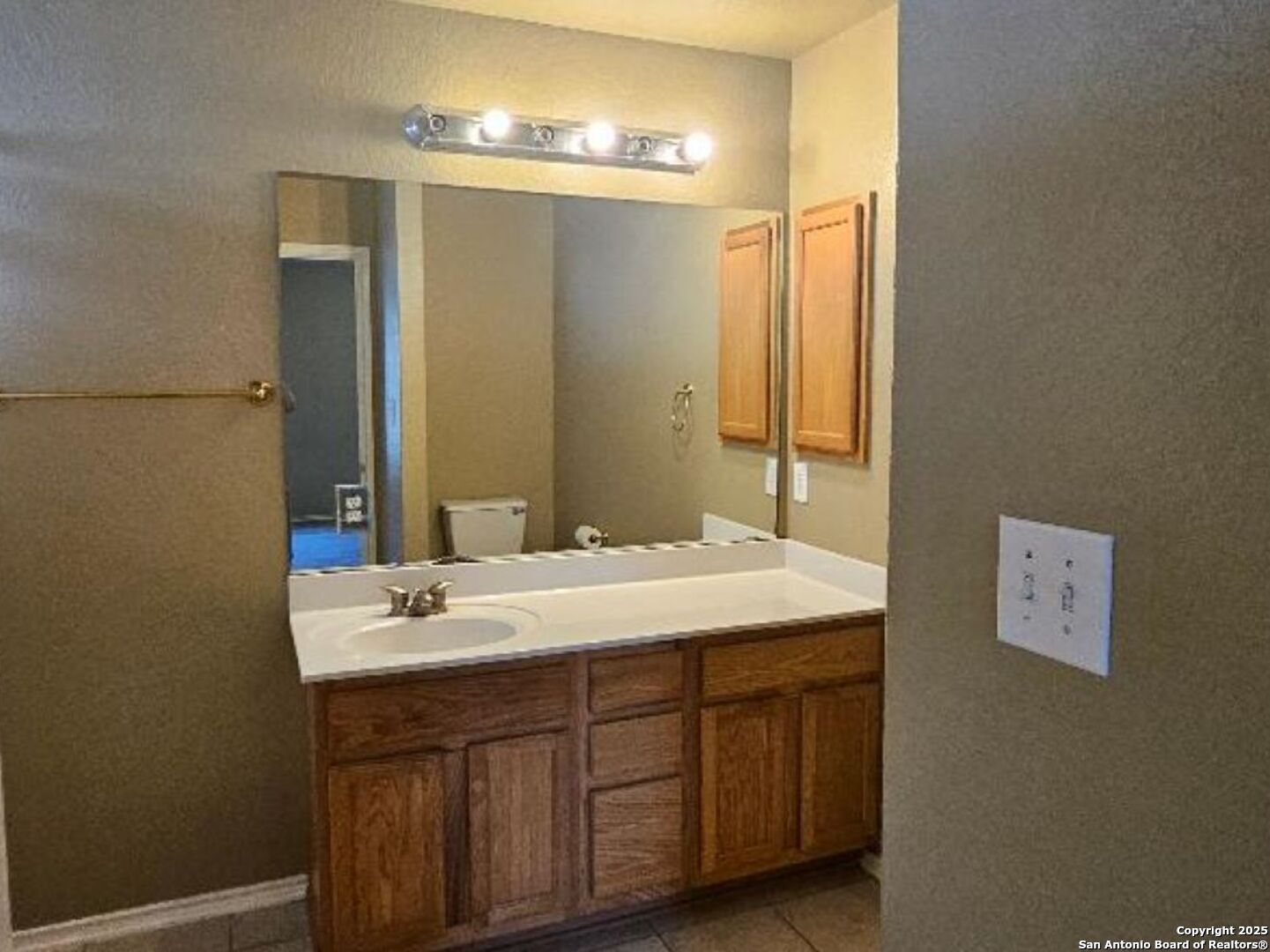 9019 Burnt Peak Helotes, TX 78023 - Photo 6 of 11 a bathroom with a sink and a mirror