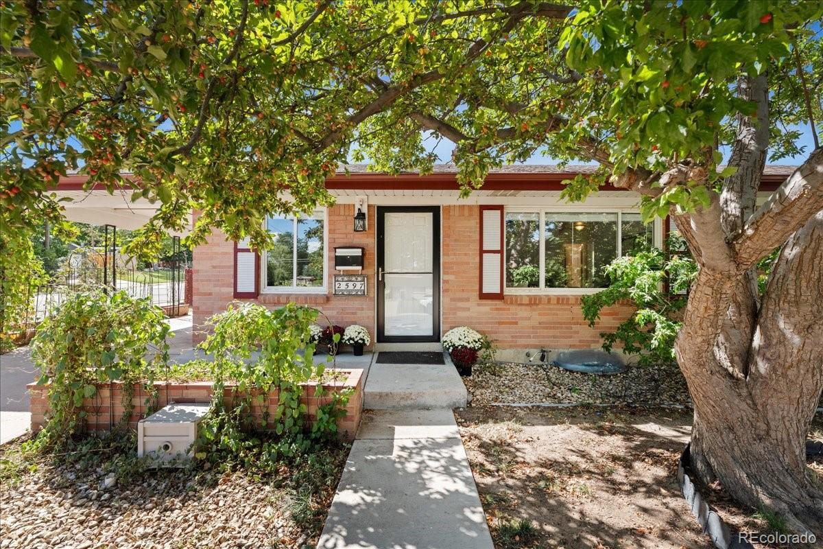 2597 South Perry Street Denver, CO 80219 - Photo 1 of 33 a front view of a house with garden