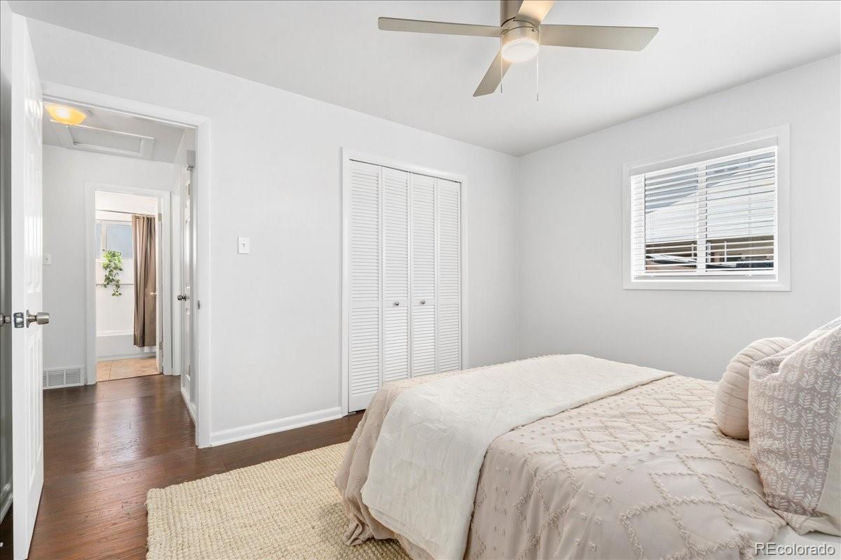 2597 South Perry Street Denver, CO 80219 - Photo 14 of 33 a bedroom with a bed and wooden floor
