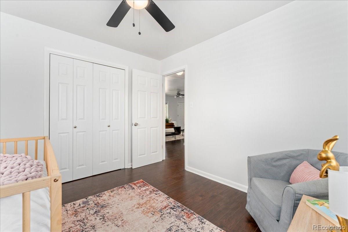 2597 South Perry Street Denver, CO 80219 - Photo 16 of 33 a bedroom with a bed and a couch