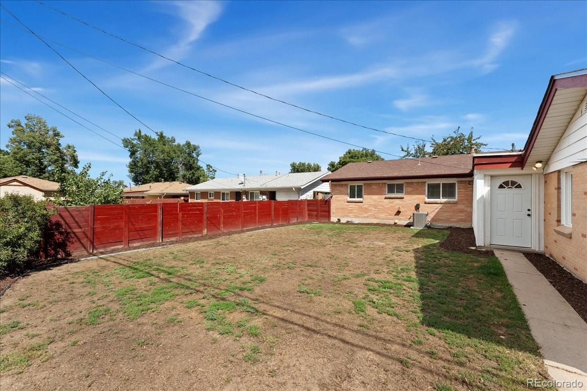 2597 South Perry Street Denver, CO 80219 - Photo 28 of 33 front view of a house with a yard