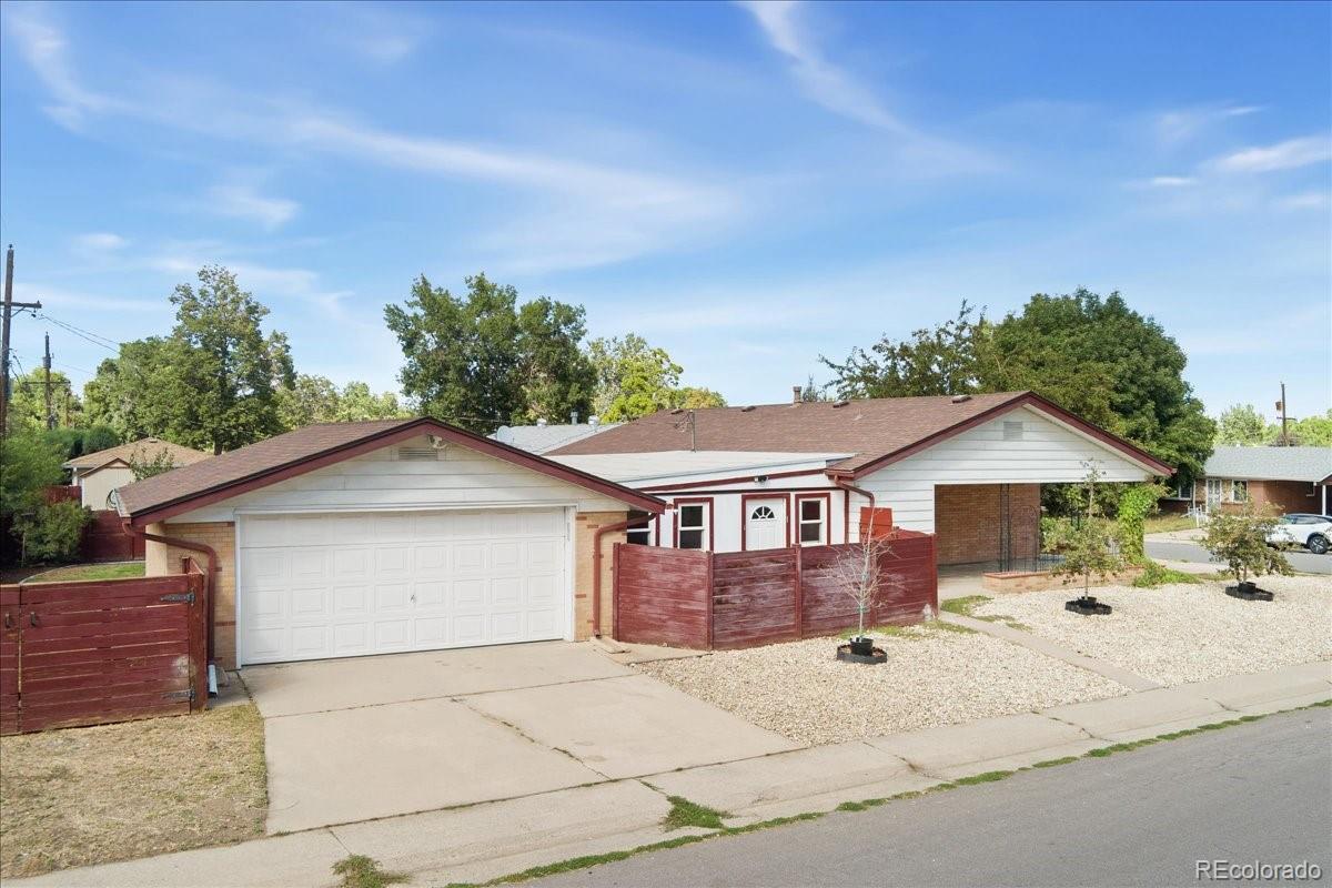2597 South Perry Street Denver, CO 80219 - Photo 4 of 33 a front view of a house with a yard and garage