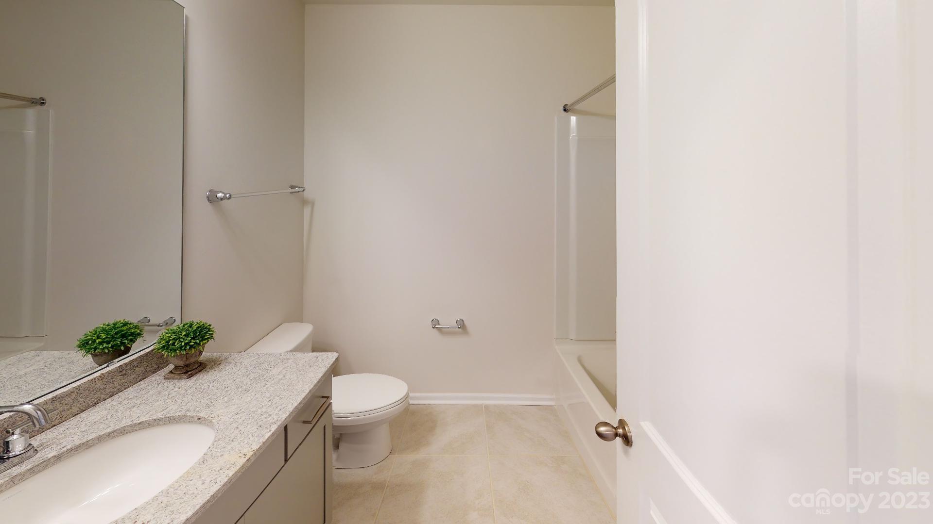 44 Ravens Rdg Road Hendersonville, NC 28792 - Photo 33 of 38 a bathroom with a granite countertop sink a toilet and shower