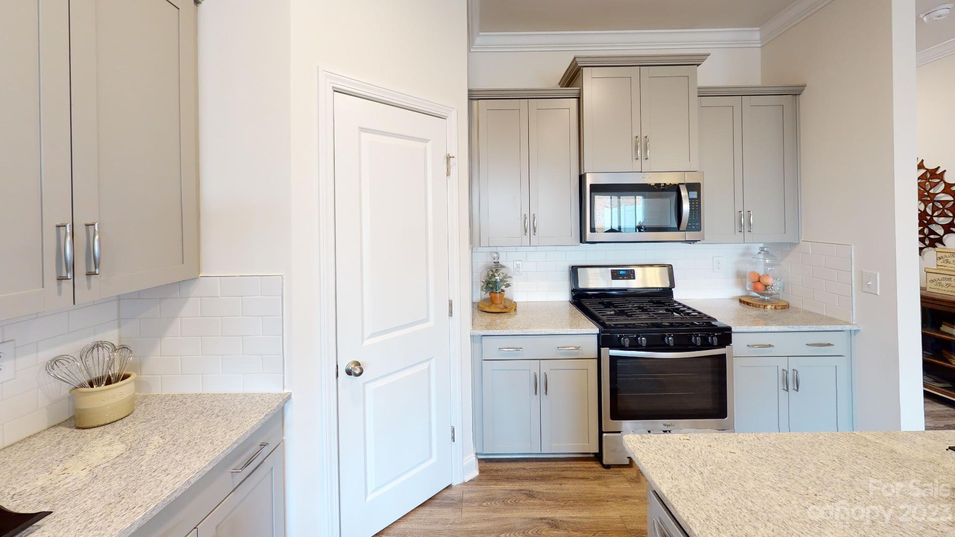 44 Ravens Rdg Road Hendersonville, NC 28792 - Photo 8 of 38 a kitchen with stainless steel appliances granite countertop a sink stove and cabinets
