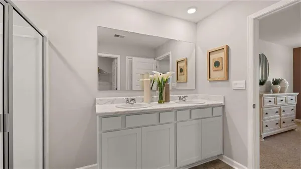 a bathroom with a double vanity sink and mirror