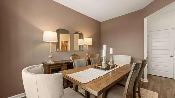 a view of a dining room with a table and chairs