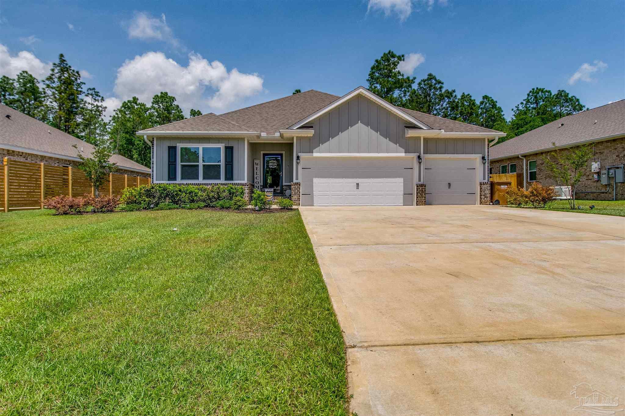 8024 Silver Maple Drive Milton, FL 32583 - Photo 1 of 43 a front view of a house with a yard
