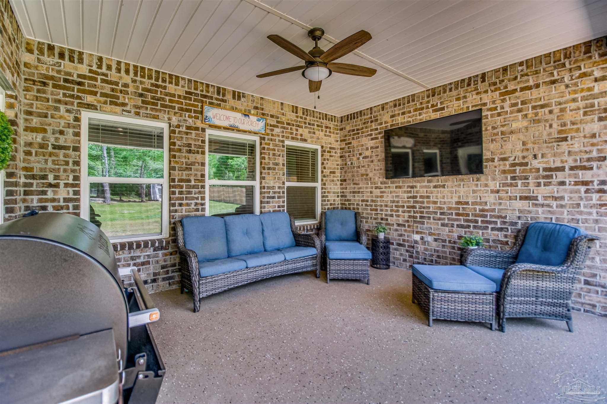 8024 Silver Maple Drive Milton, FL 32583 - Photo 13 of 43 a living room with furniture and a fireplace