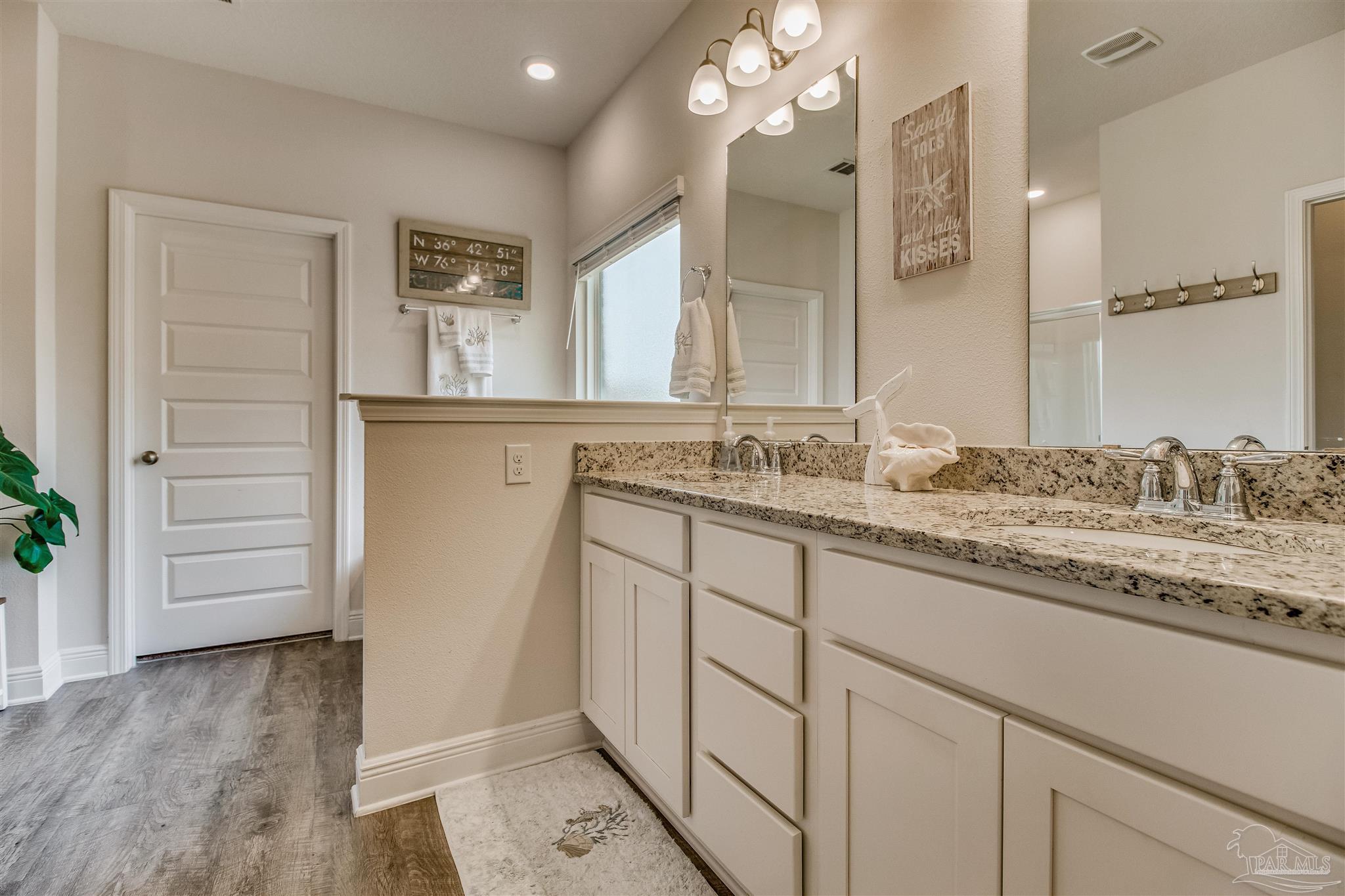 8024 Silver Maple Drive Milton, FL 32583 - Photo 17 of 43 a bathroom with a granite countertop sink mirror and vanity