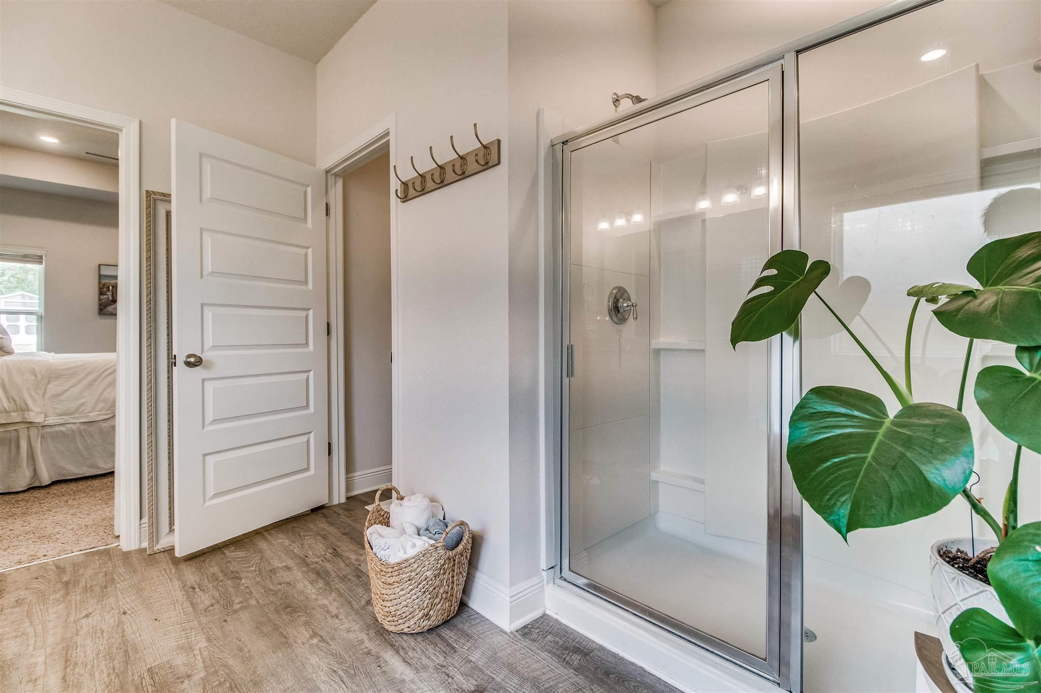 8024 Silver Maple Drive Milton, FL 32583 - Photo 18 of 43 a bathroom with a shower and a tub