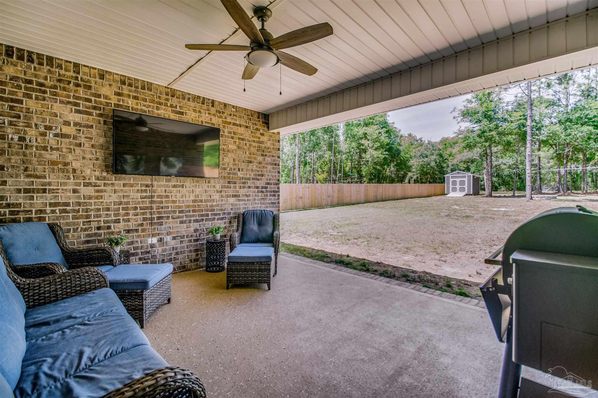 8024 Silver Maple Drive Milton, FL 32583 - Photo 19 of 43 a backyard of a house with seating space