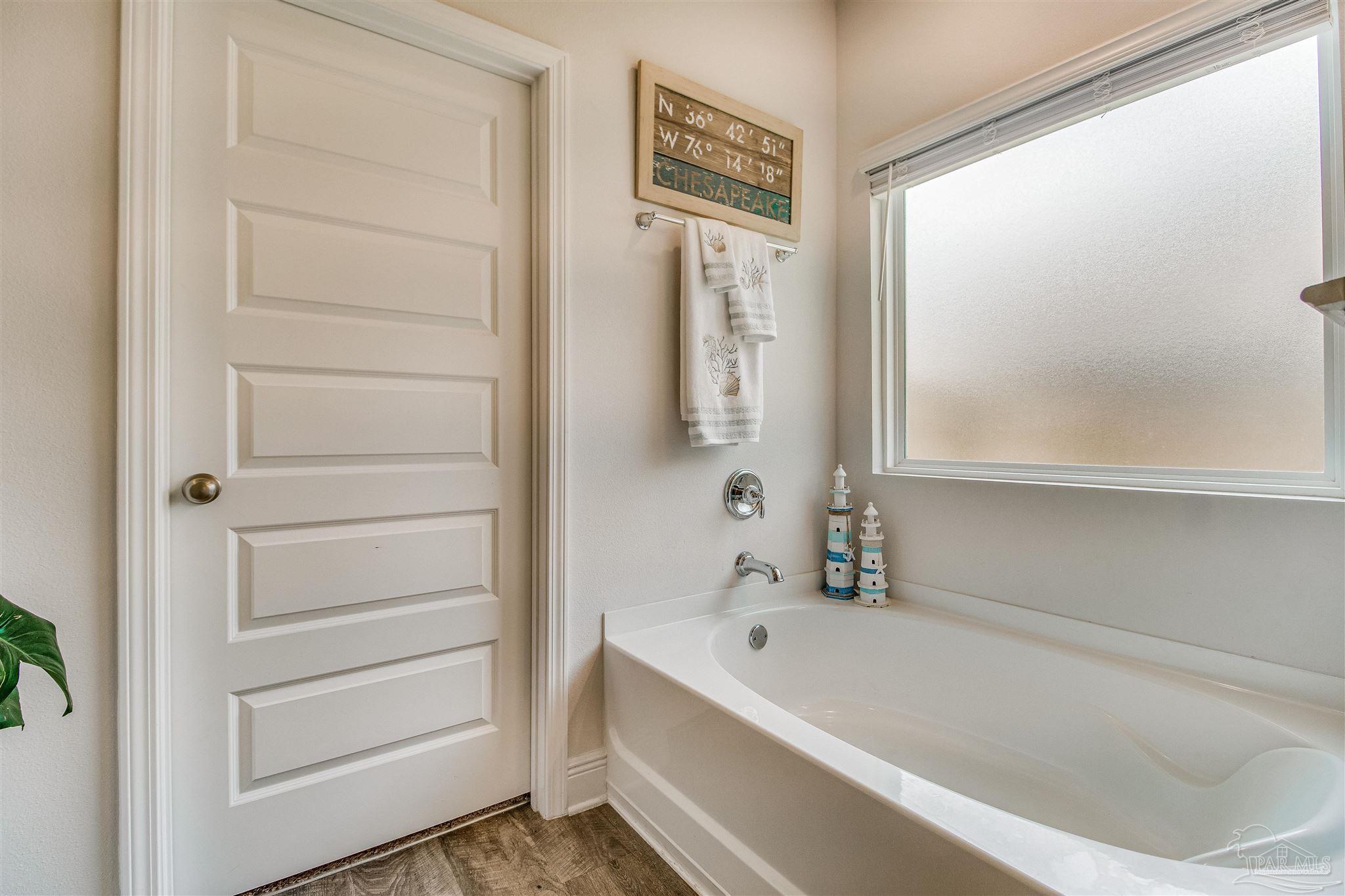8024 Silver Maple Drive Milton, FL 32583 - Photo 21 of 43 a bathroom with a bathtub and a shower