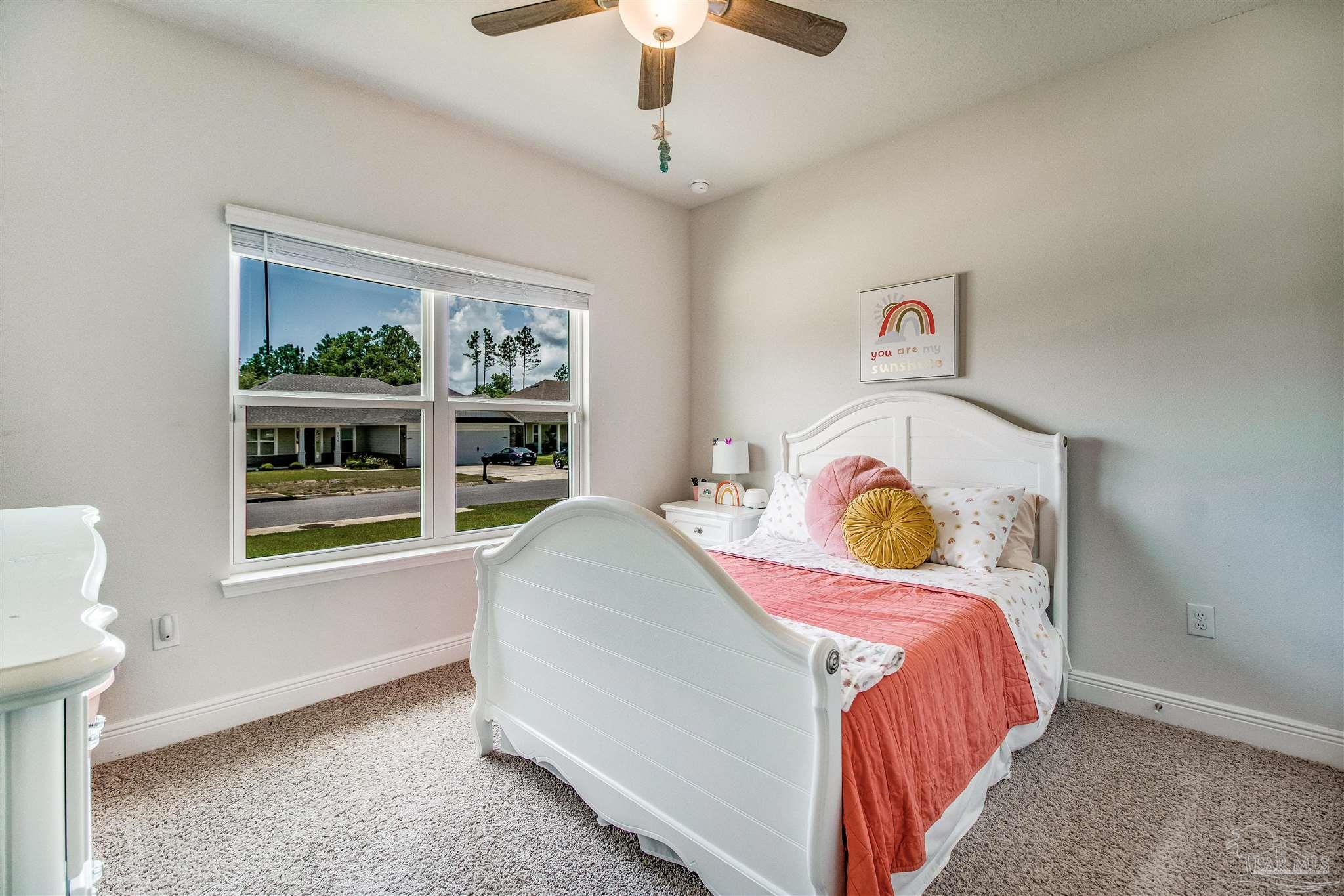 8024 Silver Maple Drive Milton, FL 32583 - Photo 22 of 43 a bedroom with a bed and a window