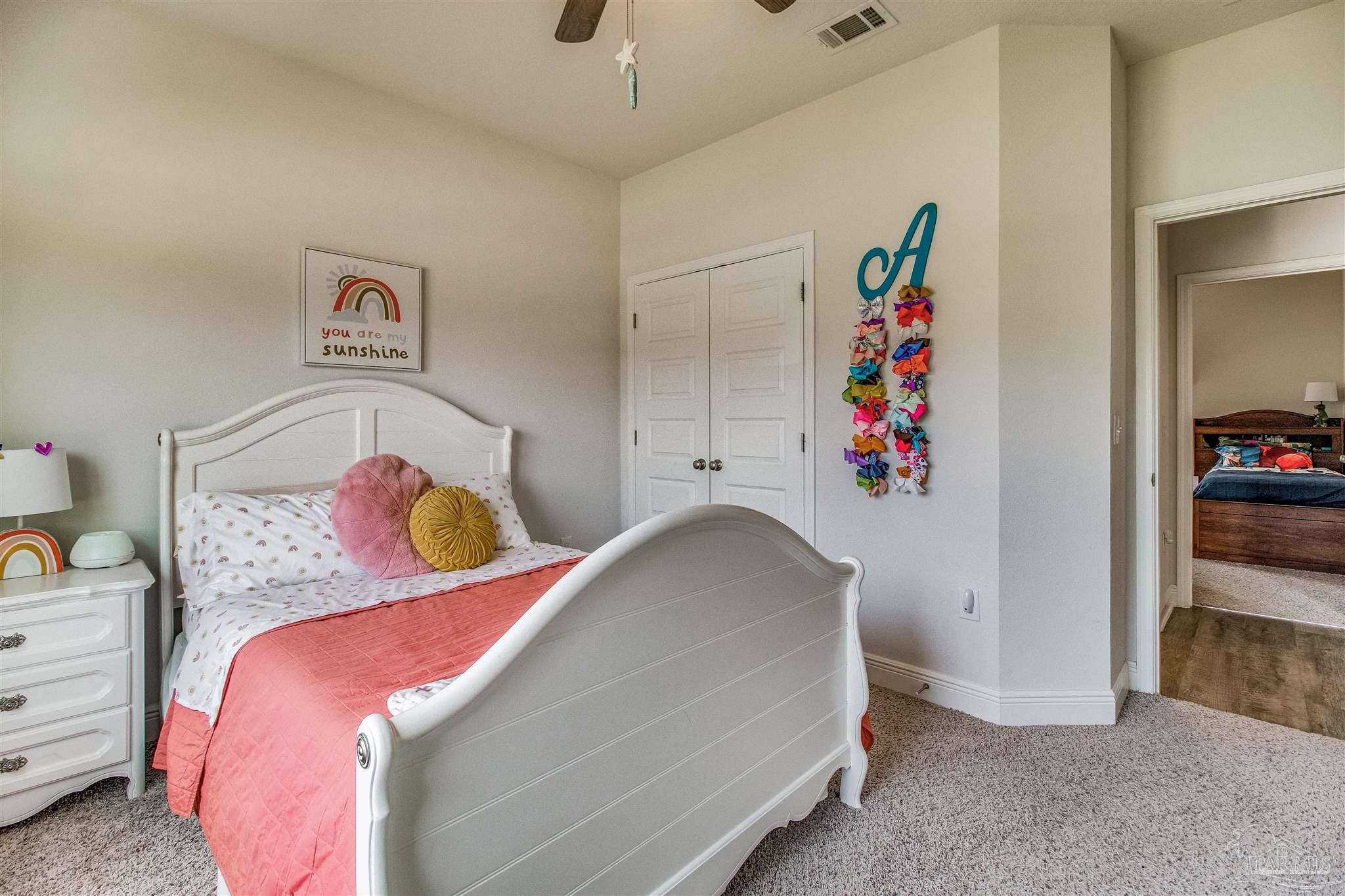 8024 Silver Maple Drive Milton, FL 32583 - Photo 23 of 43 a bedroom with a bed and cabinets