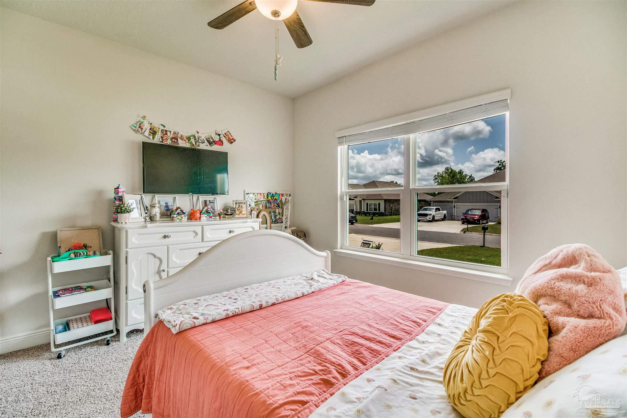 8024 Silver Maple Drive Milton, FL 32583 - Photo 25 of 43 a bedroom with a bed and a window